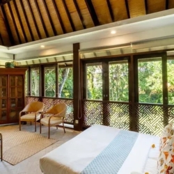 Asraya villa bright second floor living space with thatched roof daybed decorative screen and jungle view sanur 870x500