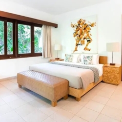 Asraya villa chic villa bedroom featuring a queen sized bed unique contemporary artwork large windows and a comfortable leather bench sanur 870x500