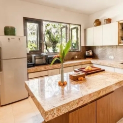 Asraya villa fully equipped modern villa kitchen featuring a large granite island stainless steel refrigerators and ample cabinet storage sanur 870x500