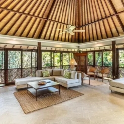 Asraya villa luxurious living area with exposed beam ceiling plush sectional sofa glass doors and daybed sanur 870x500