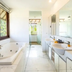 Asraya villa luxurious master suite bathroom with white marble counters jetted tub and double vanities for couples sanur 870x500