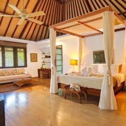 Asraya villa spacious master suite with canopy bed wooden floors ceiling fan and working desk sanur 870x500