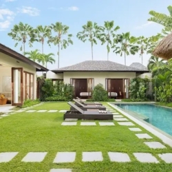 The suar beautiful private villa pool area with lush green lawn and comfortable lounge chairs seminyak 870x500