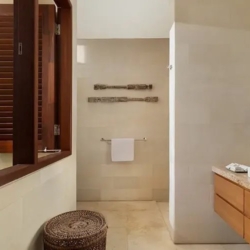 The suar beautifully designed bathroom with natural wood accents and an open window with lush tropical plants seminyak 870x500