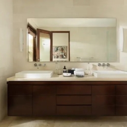 The suar luxurious bathroom area with a sleek dark wood vanity and a view of lush tropical greenery seminyak 870x500