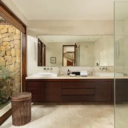 The suar luxurious bathroom area with a sleek double vanity and a stunning stone outdoor shower seminyak 870x500