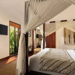 The suar spacious connecting bedroom with a comfortable bed and beautiful view of the garden seminyak 870x500