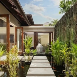 The suar tranquil garden pathway koi pond buddha statue seminyak 870x500
