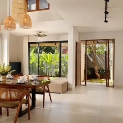 Villa ananya bright living dining area wooden table peacock painting seminyak 870x500