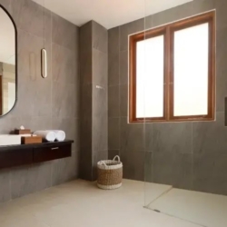 Villa ananya contemporary grey tiled bathroom with sleek vanity and walk in shower seminyak 870x500