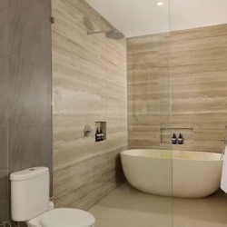 Villa ananya modern bathroom white oval bathtub glass shower seminyak 870x500